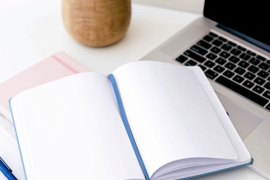 Notebook with blue bookmark ready for notes from a strategy session on SEO and google visibility for therapists