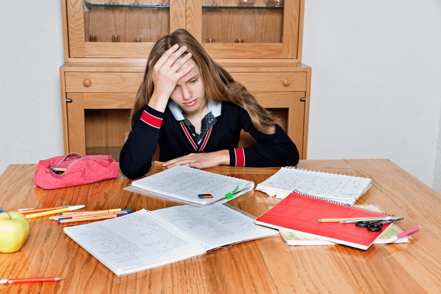 Overwhelmed girl with homework at her table ready to heal with an EMDR Intensive