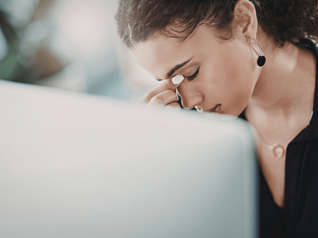 Woman therapist holding her nose in frustration over building her private practice website needing support with SEO and Marketing services